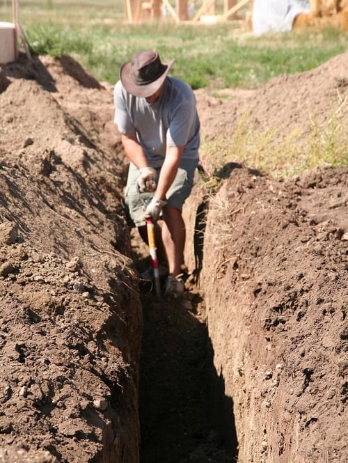 Best Trenching Shovel - Man digging large trench by hand