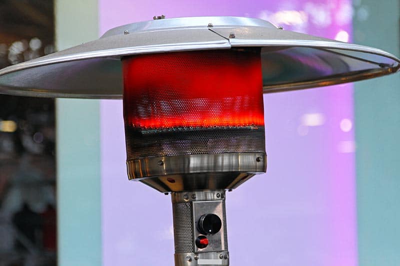 A Propane patio heater with a dome cover in action